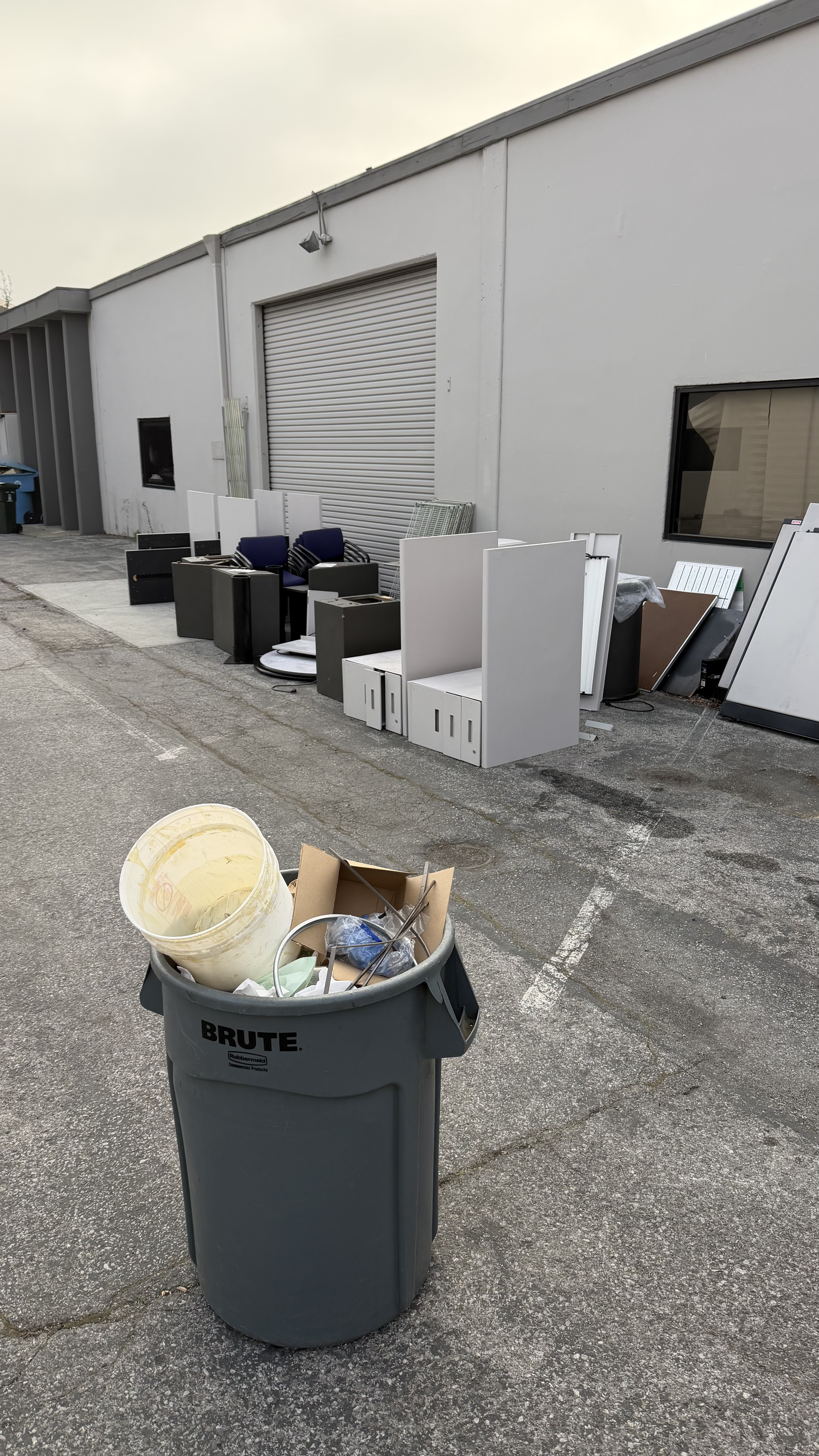 Before — commercial space full of office furniture and debris