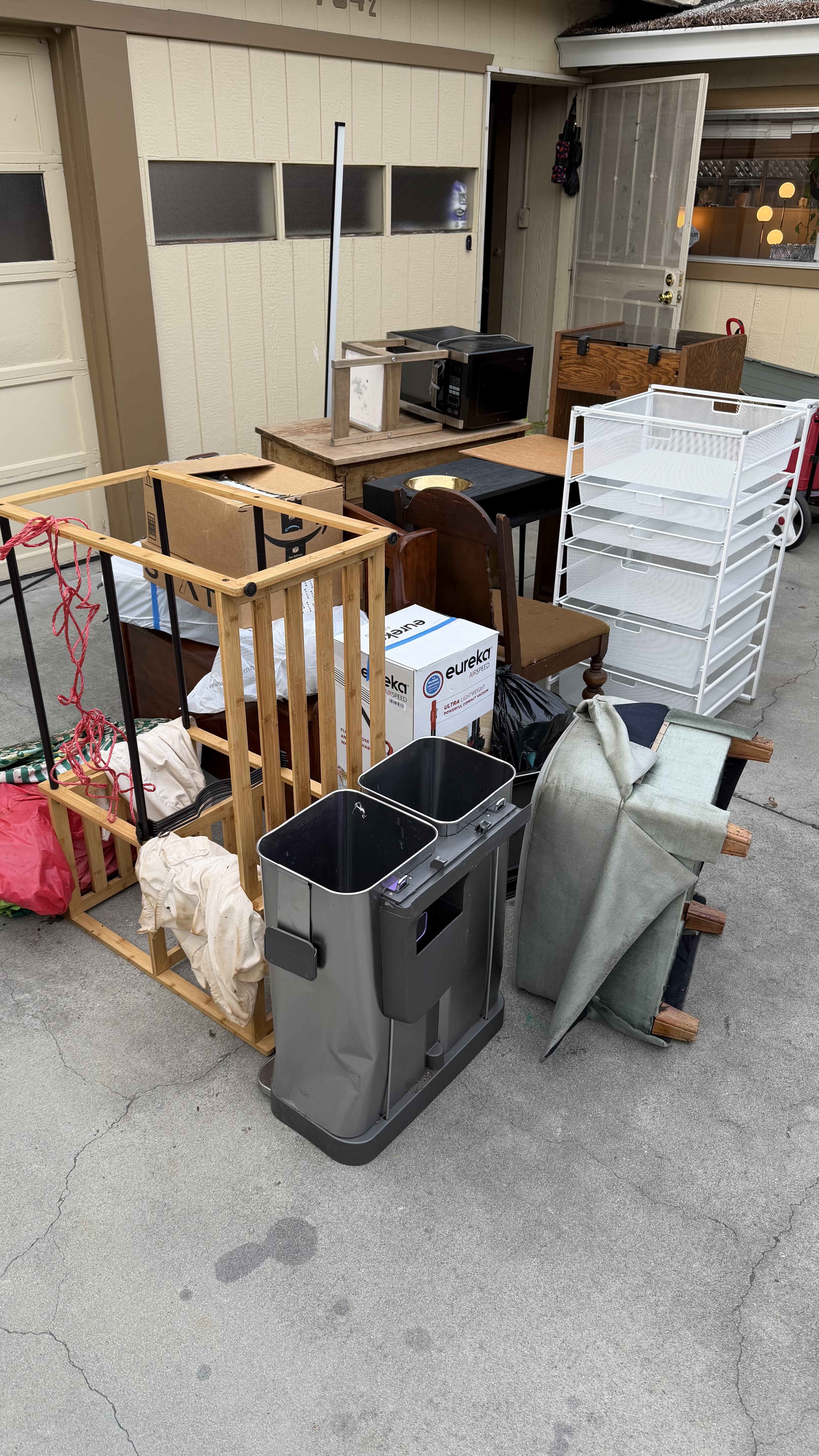 Before — driveway piled with furniture and household junk